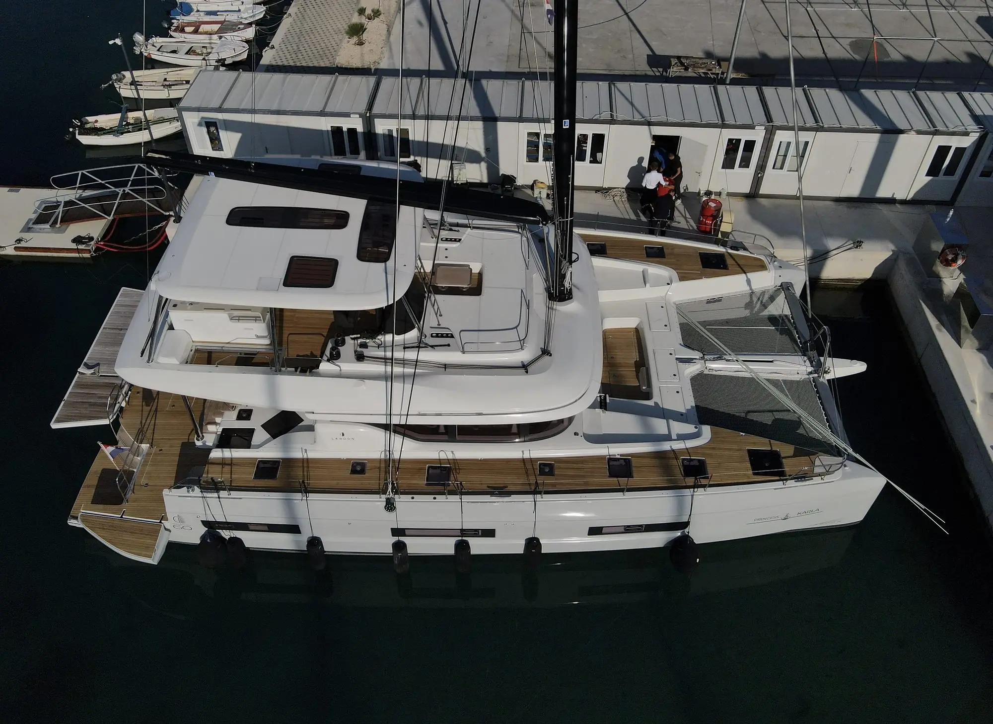 Lagoon 60 teak deck by ATT Nautica: aft cockpit and swim platforms from the air